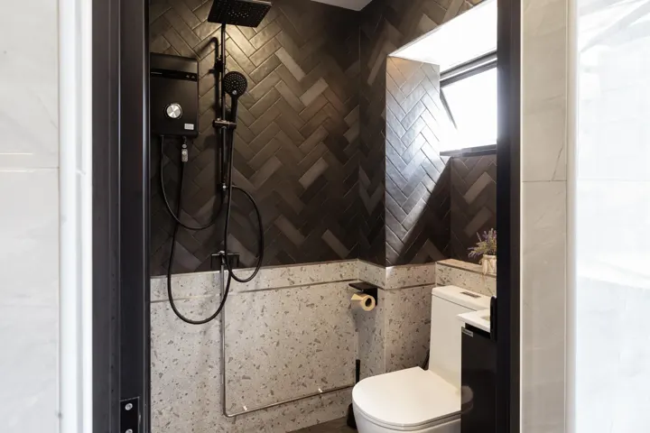 Bathroom with herringbone tiles by The Masterplan Studio